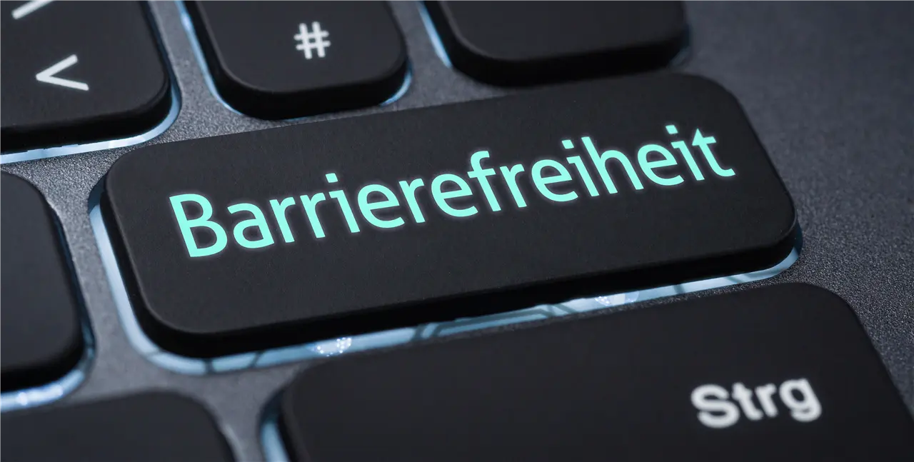 Die Grafik zeigt eine Computertaste mit dem Wort "Barrierefreiheit" auf einer deutschen Tastatur.